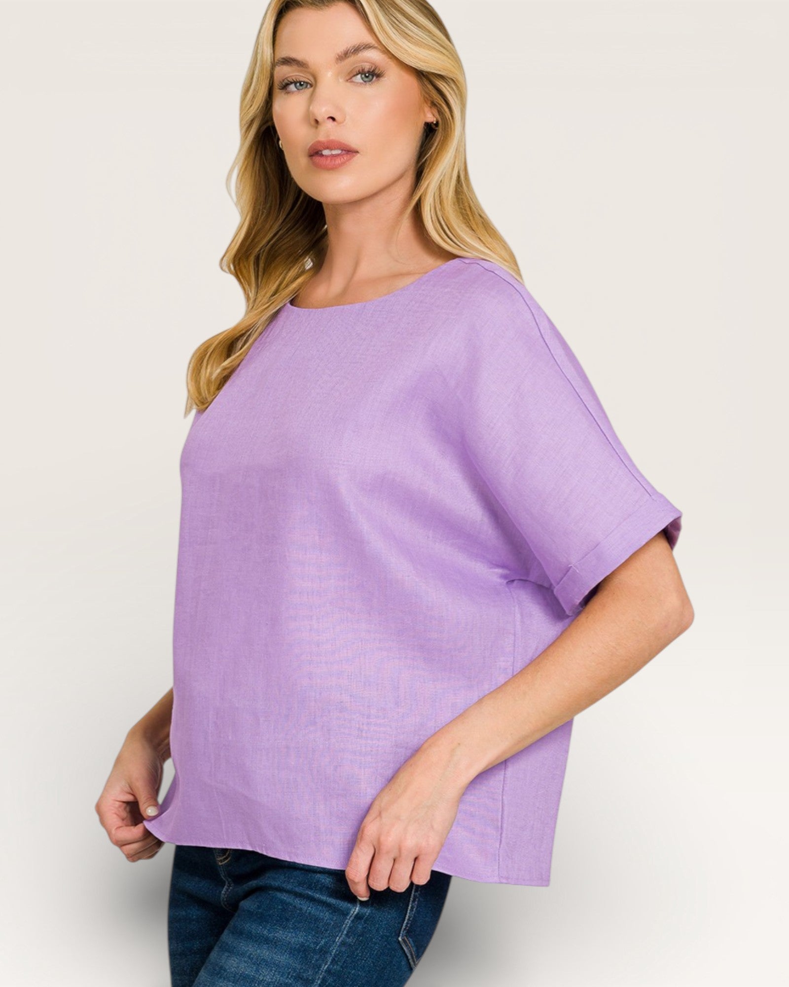 Woman wearing a purple top on a plain background