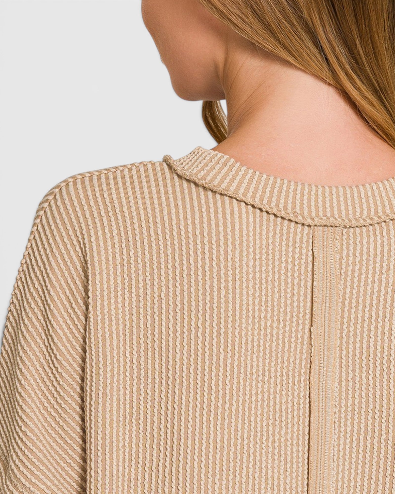 Close-up of a textured beige jacket with a blurred background