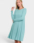 Woman wearing a light blue dress on a white background