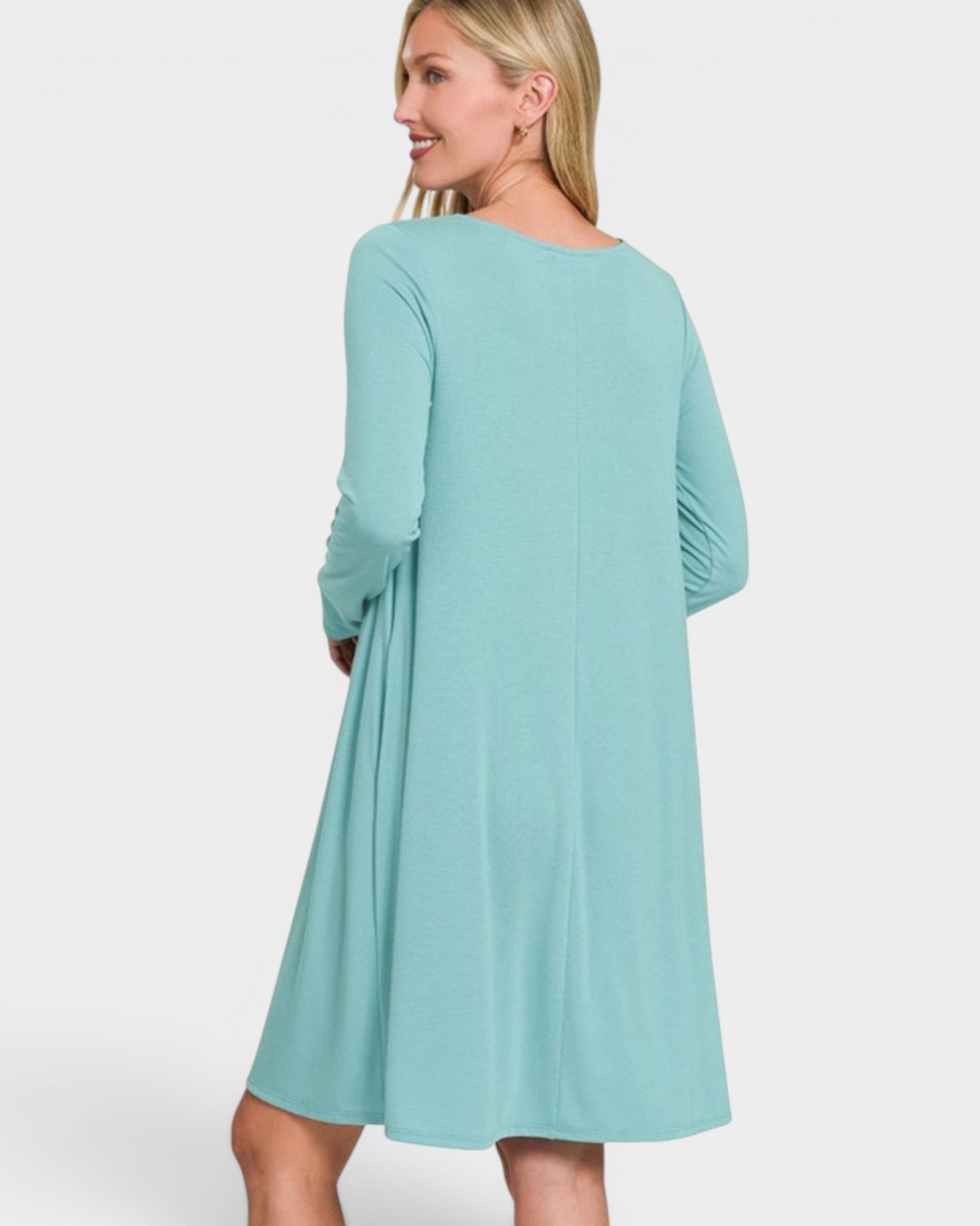 Woman wearing a light blue dress on a white background