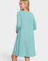 Woman wearing a light blue dress on a white background