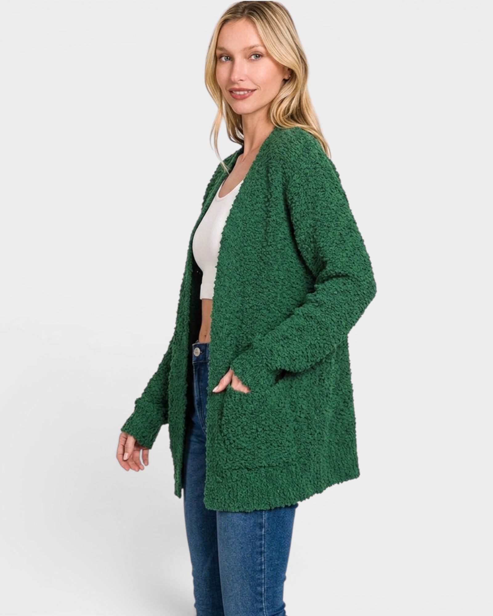 Woman wearing a green cardigan on a white background