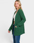 Woman wearing a green cardigan on a white background