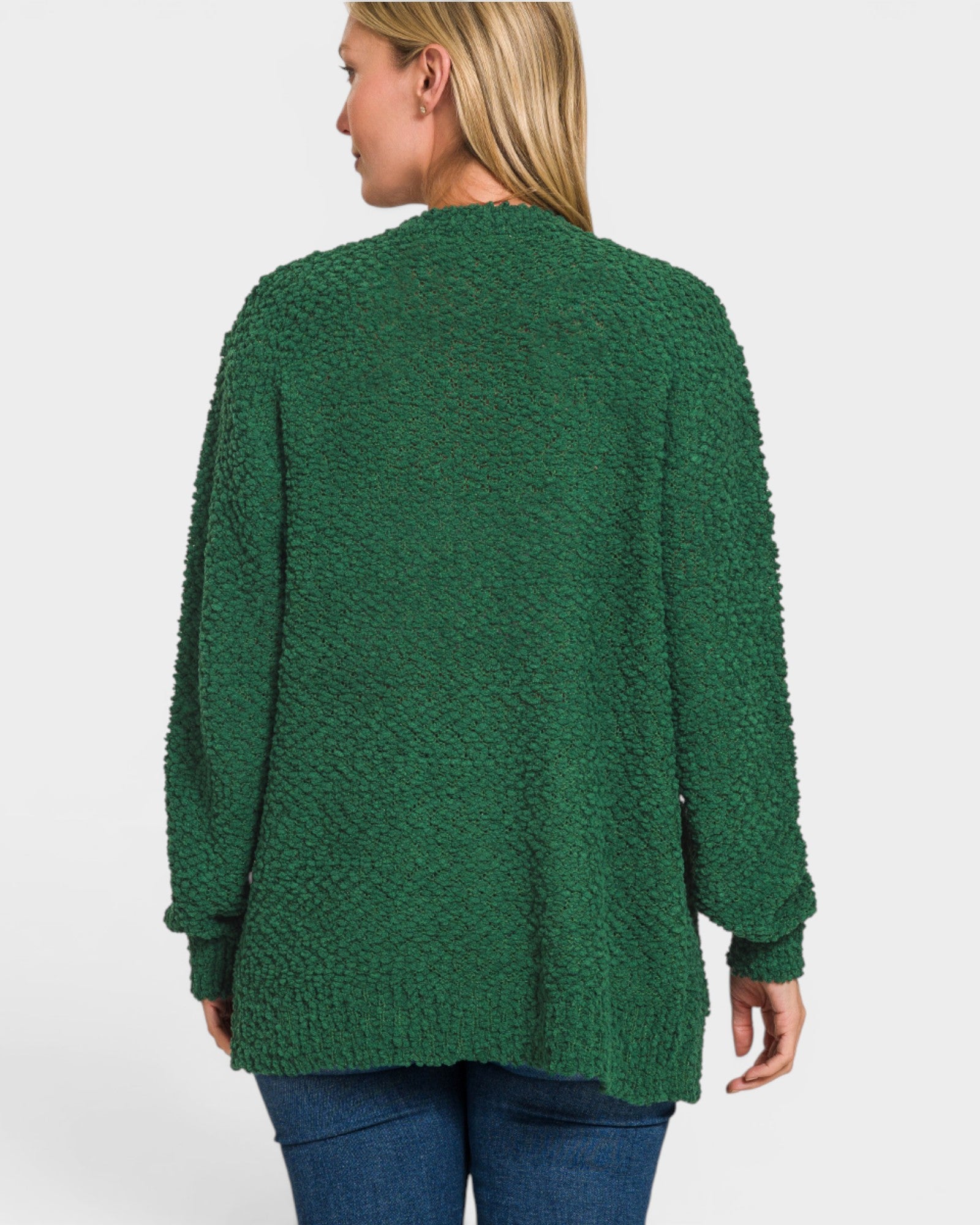 Green cardigan worn by a person on a white background