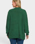 Green cardigan worn by a person on a white background