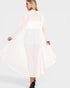 Woman wearing a light pink dress with long sleeves on a white background