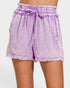 Purple denim shorts with a tie waist on a white background