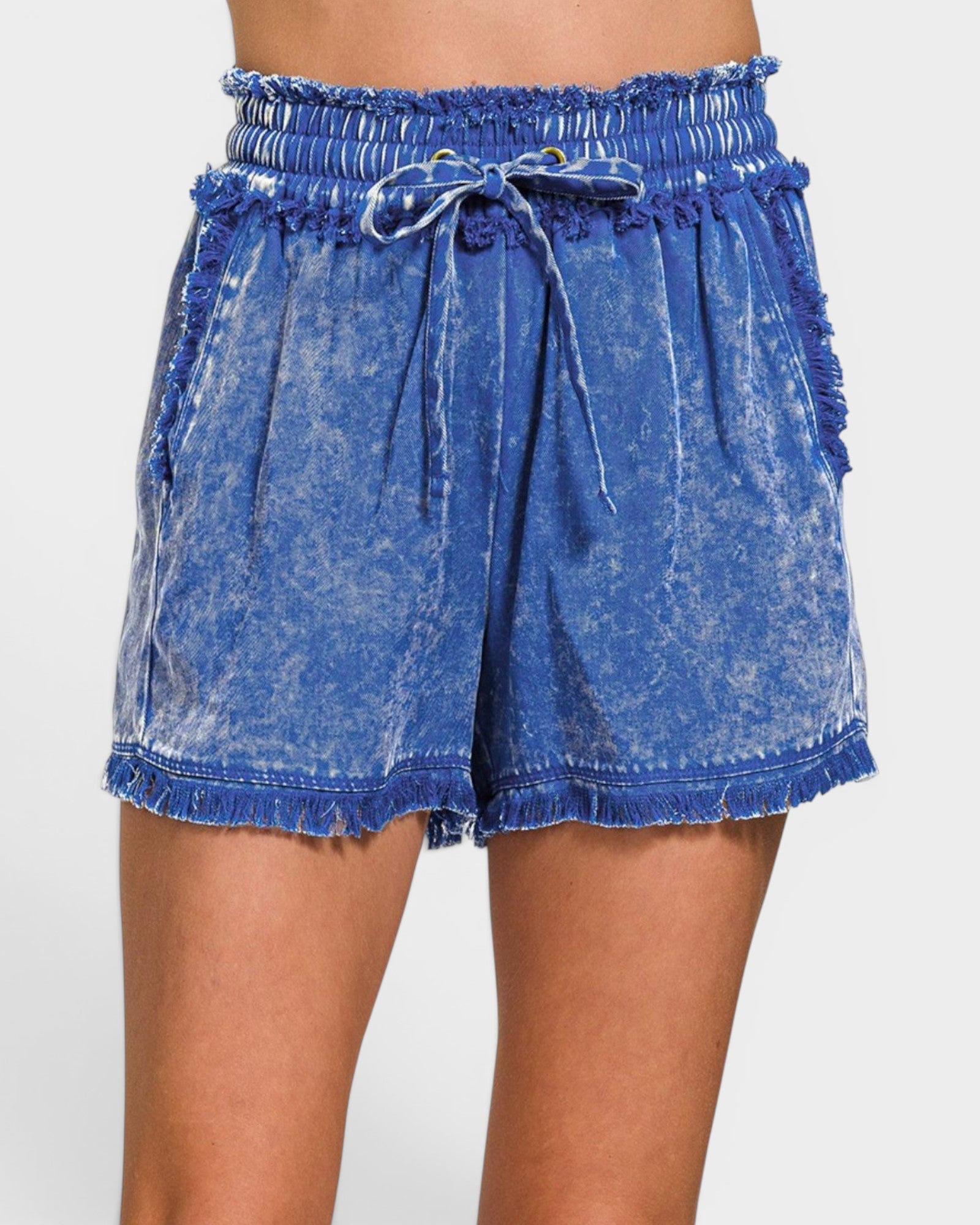Blue denim shorts with a tie waist on a white background