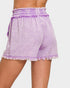 Lavender shorts with ruffled details on a plain background