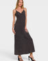 Woman wearing a dark gray slip dress on a white background