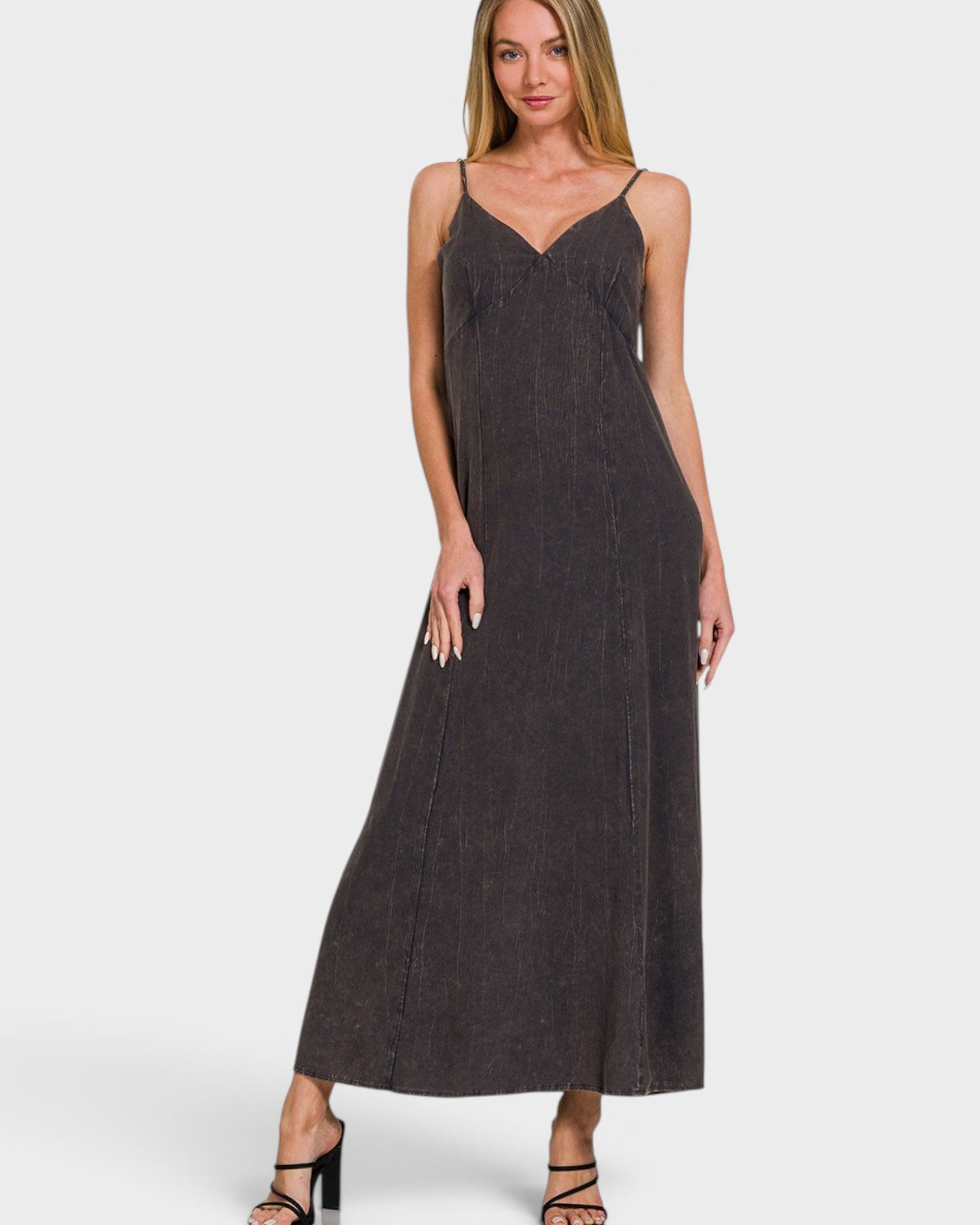Woman wearing a dark denim dress on a white background