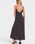 Woman wearing a dark brown slip dress on a white background