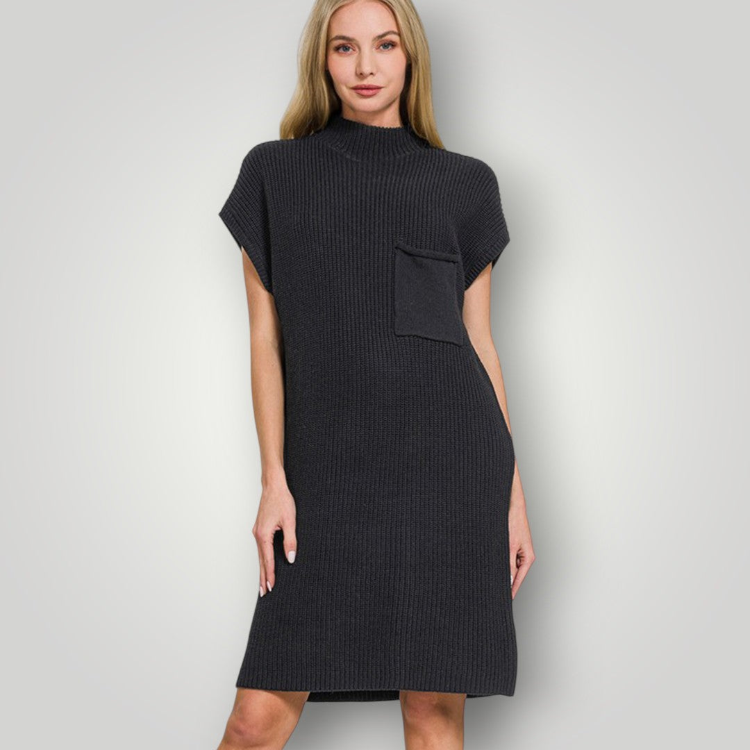 Woman wearing a black dress against a plain background