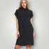 Woman wearing a black dress against a plain background