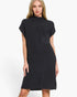A woman modeling a dark charcoal gray ribbed knit mock-neck dress with short sleeves and a chest pocket, set against a plain white studio background.