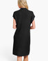 A woman shown from the back wearing a black ribbed knit mock-neck dress with short cap sleeves, photographed against a plain white studio background.