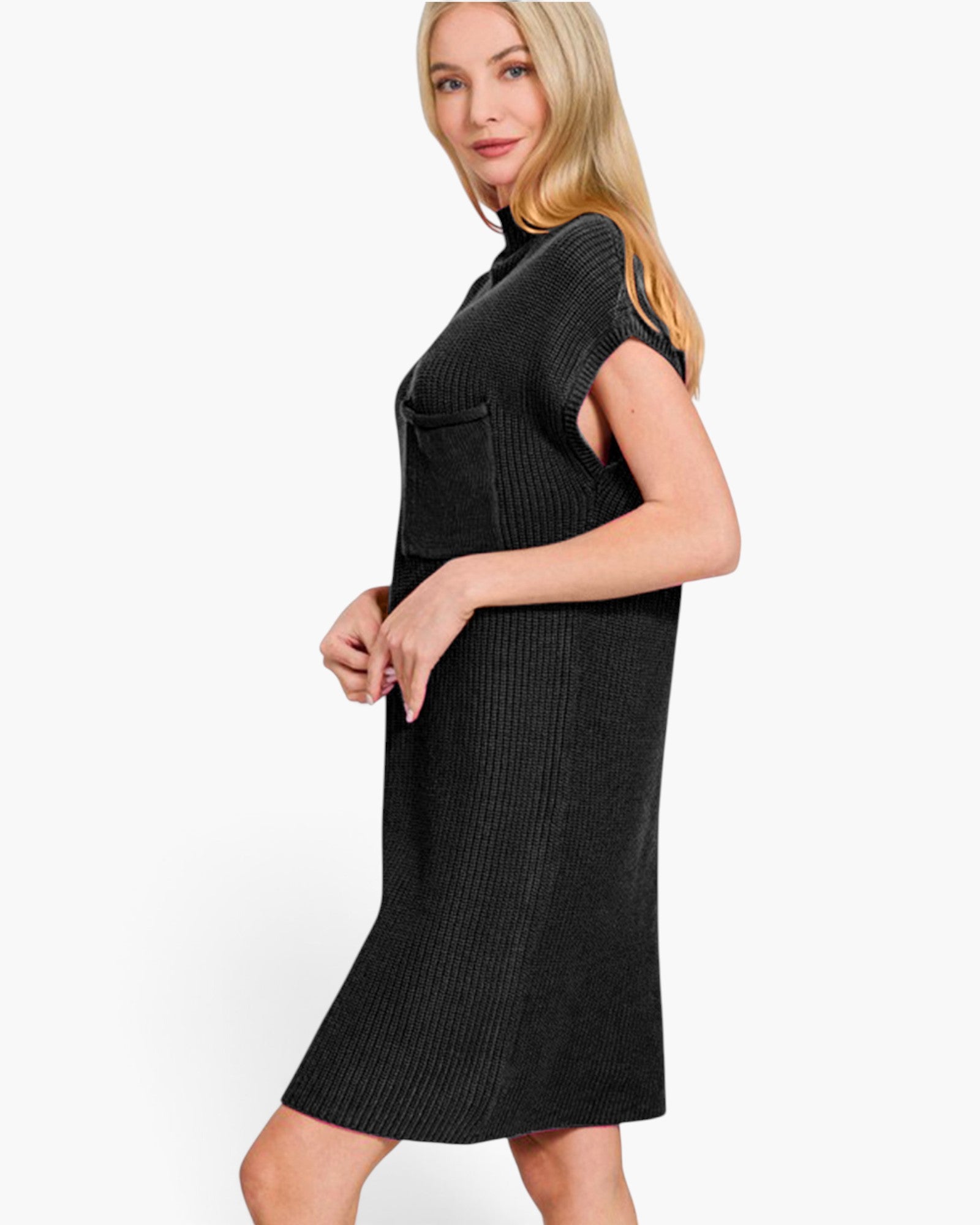 A woman modeling a black ribbed knit mock-neck dress with short sleeves and a front pocket, shown against a plain white studio background.