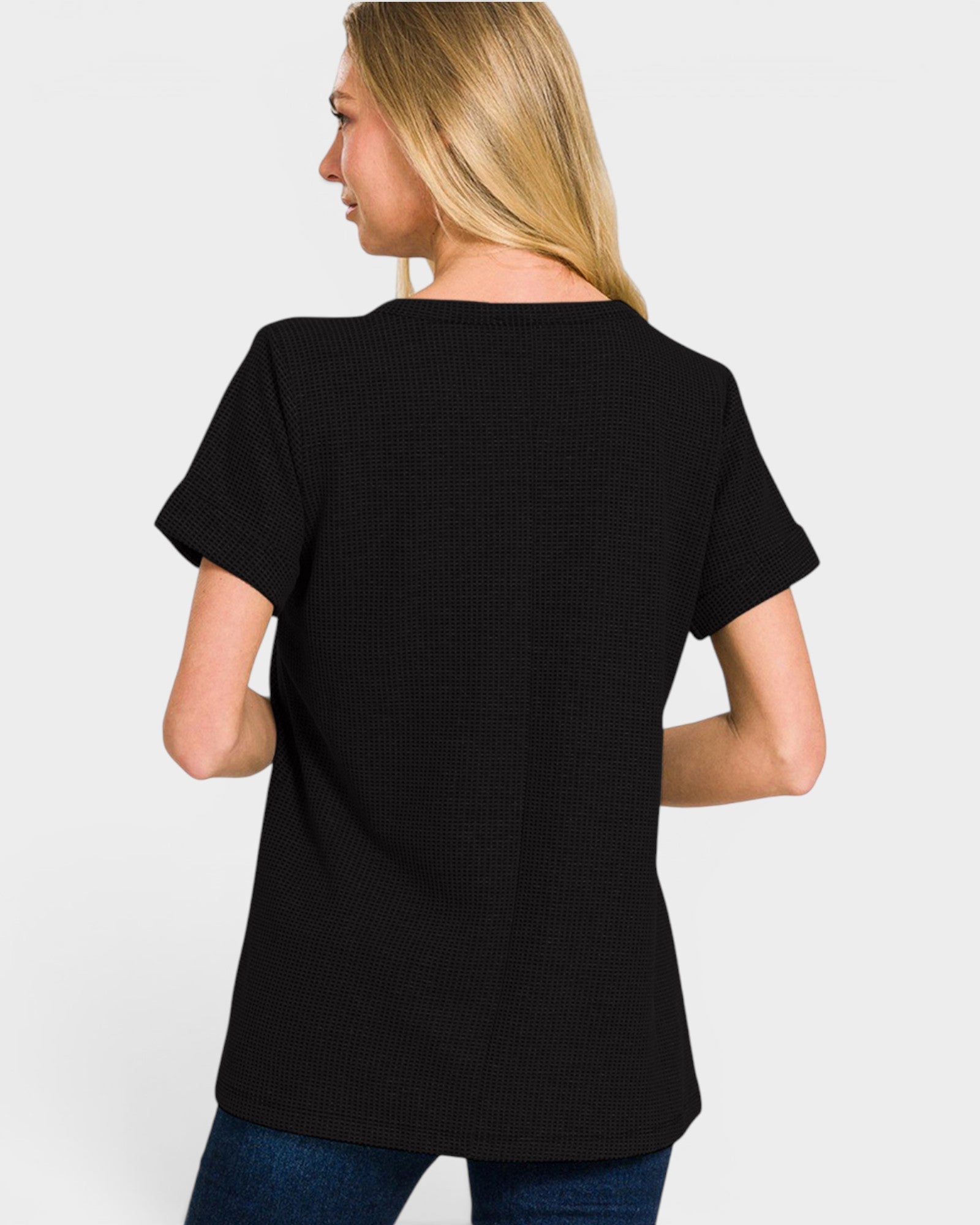 Woman wearing a black t-shirt on a plain background