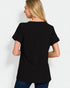 Person wearing a black t-shirt on a plain background