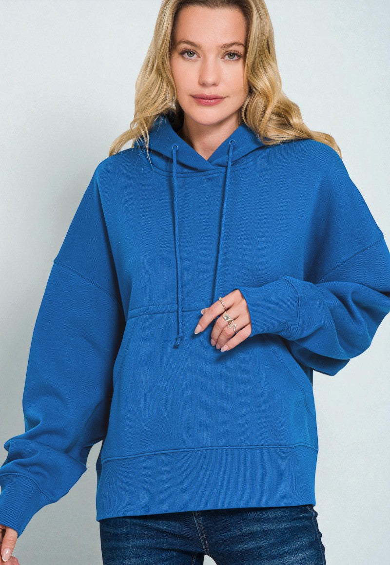 Person wearing a blue hoodie against a plain background