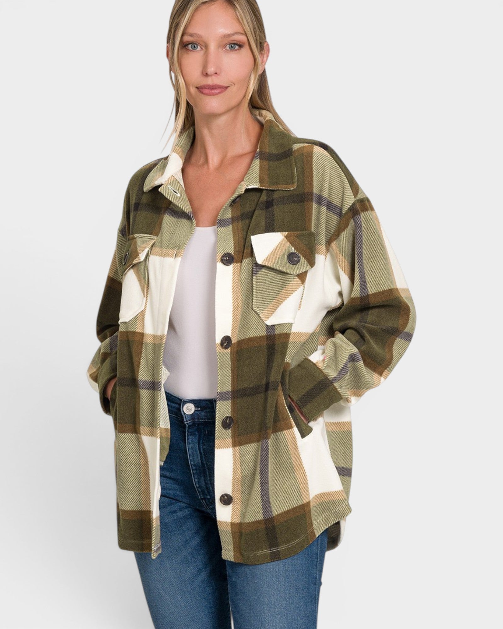 Woman wearing a plaid shirt over a white top and jeans on a white background