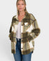 Woman wearing a plaid shirt over a white top and jeans on a white background