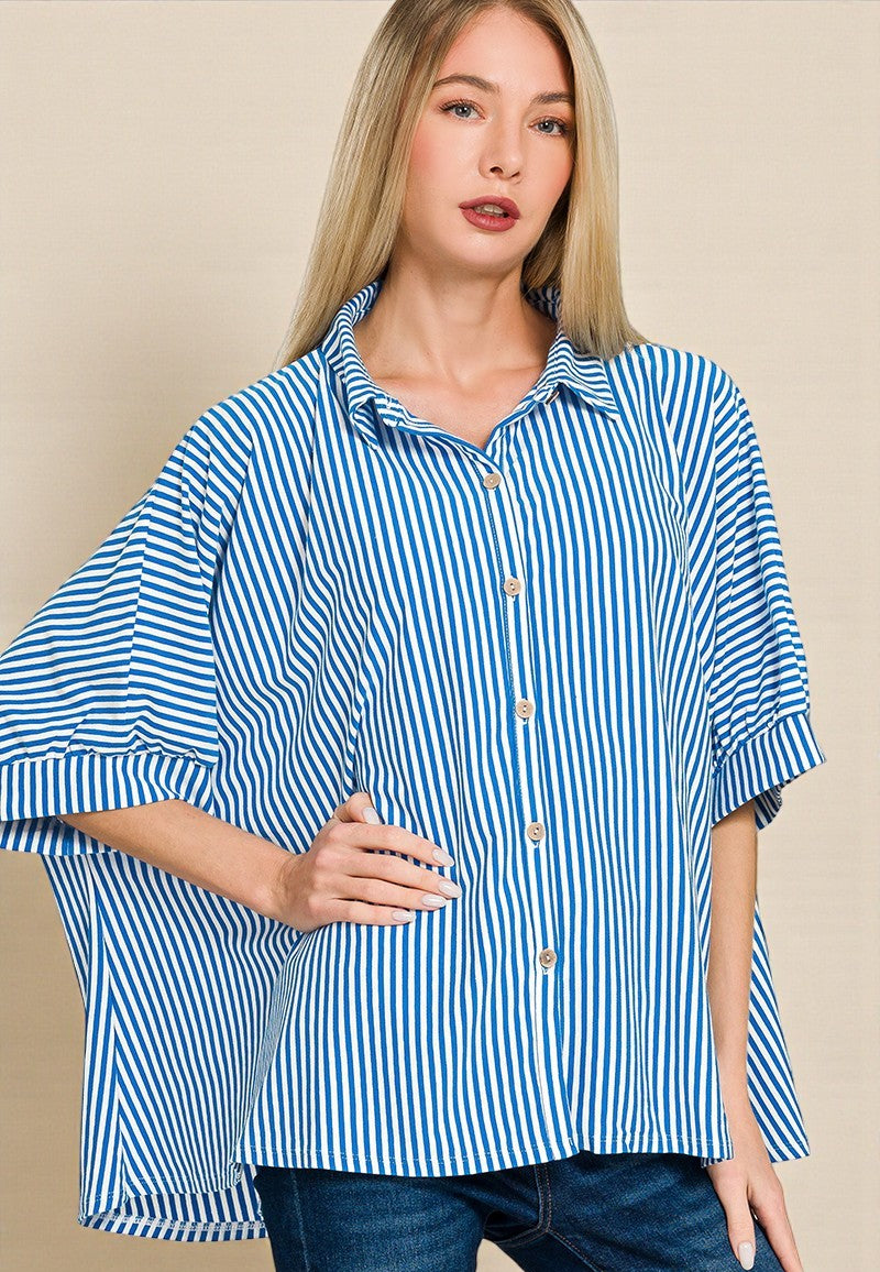 Woman wearing a blue and white striped shirt against a beige background
