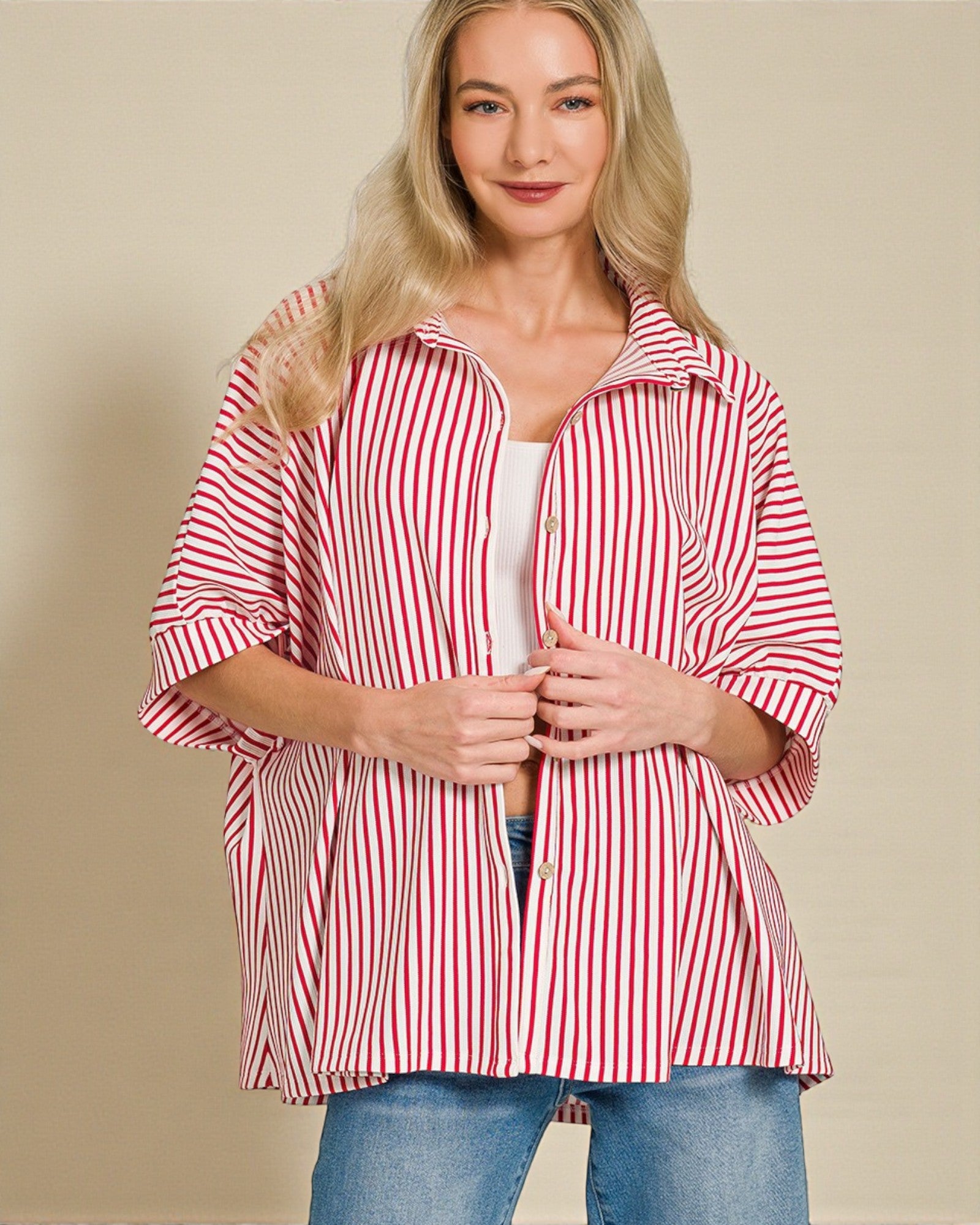 Woman wearing a red and white striped shirt against a beige background