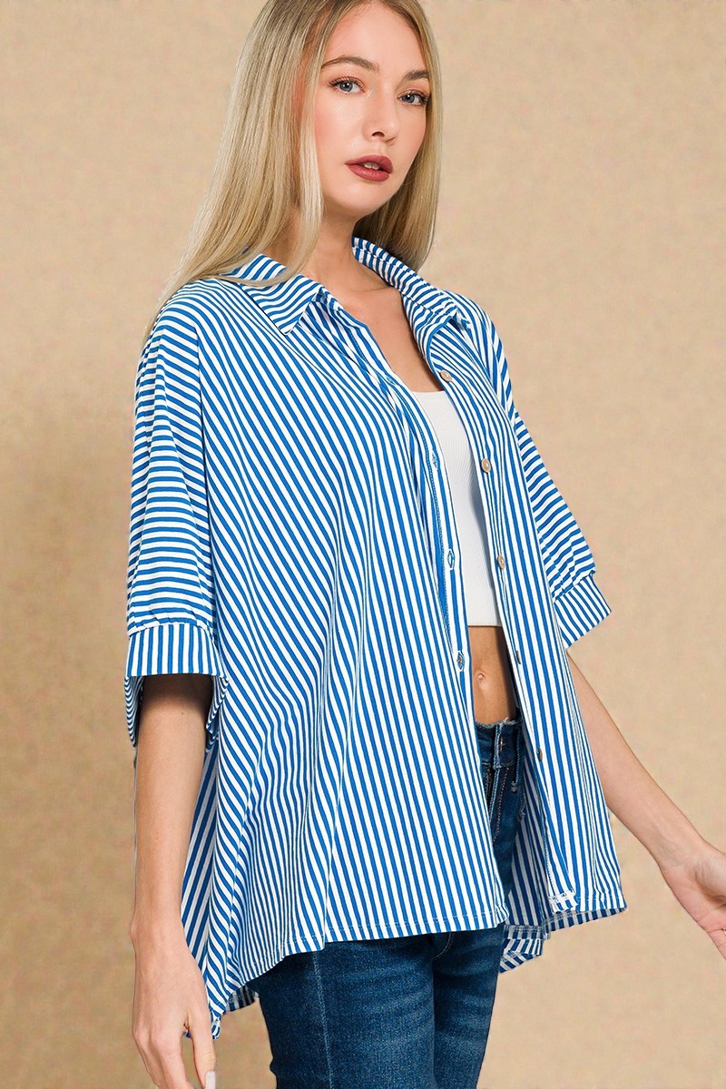 Woman wearing a blue and white striped shirt against a beige background
