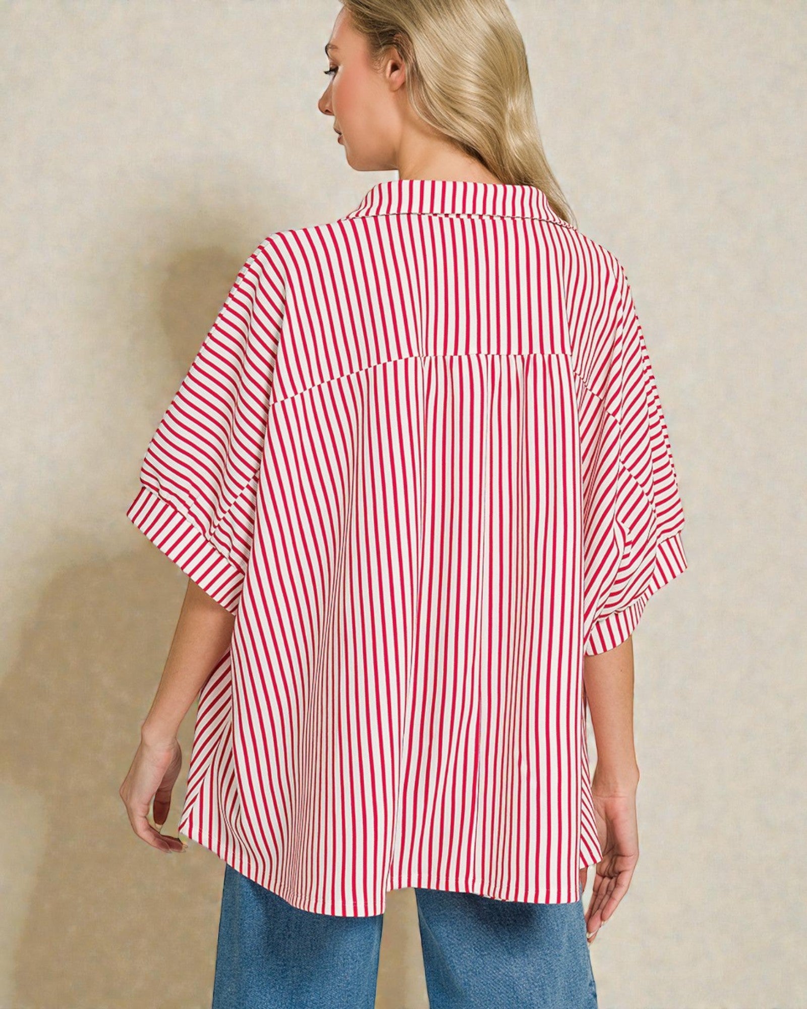 Woman wearing a red and white striped shirt against a beige background