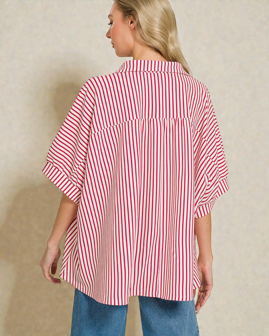 Woman wearing a red and white striped shirt against a beige background