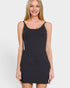 Woman wearing a black tank dress against a white background