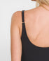 Black tank top with thin straps worn by a person on a light gray background