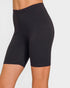 Black bike shorts worn by a person on a plain background