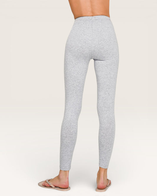 Gray leggings worn by a person on a white background