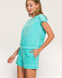 Woman wearing a turquoise outfit on a white background