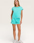 Woman wearing a turquoise outfit on a white background