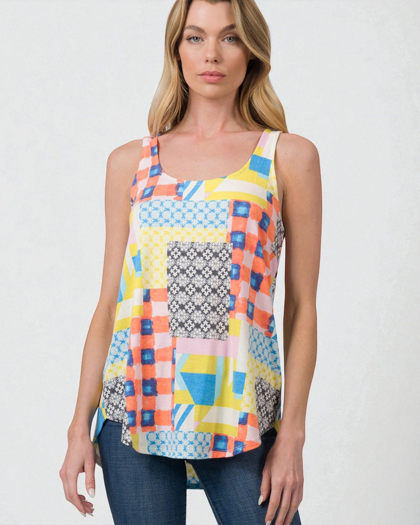 Woman wearing a colorful geometric patterned tank top against a white background