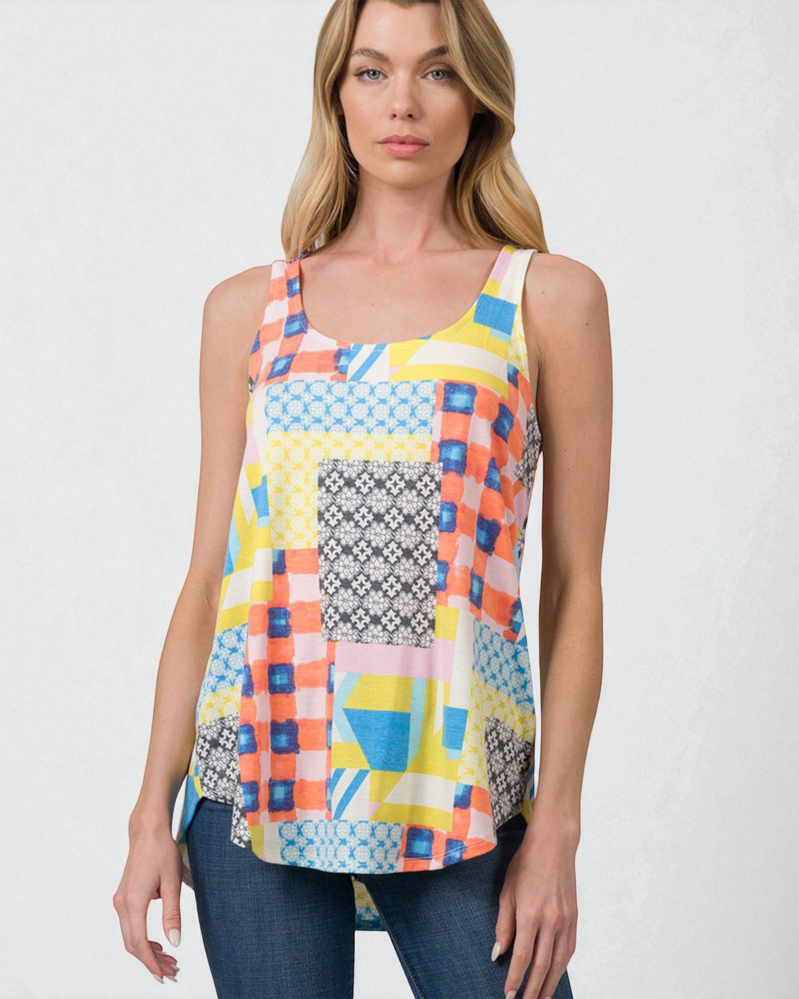 Woman wearing a colorful geometric patterned tank top against a white background