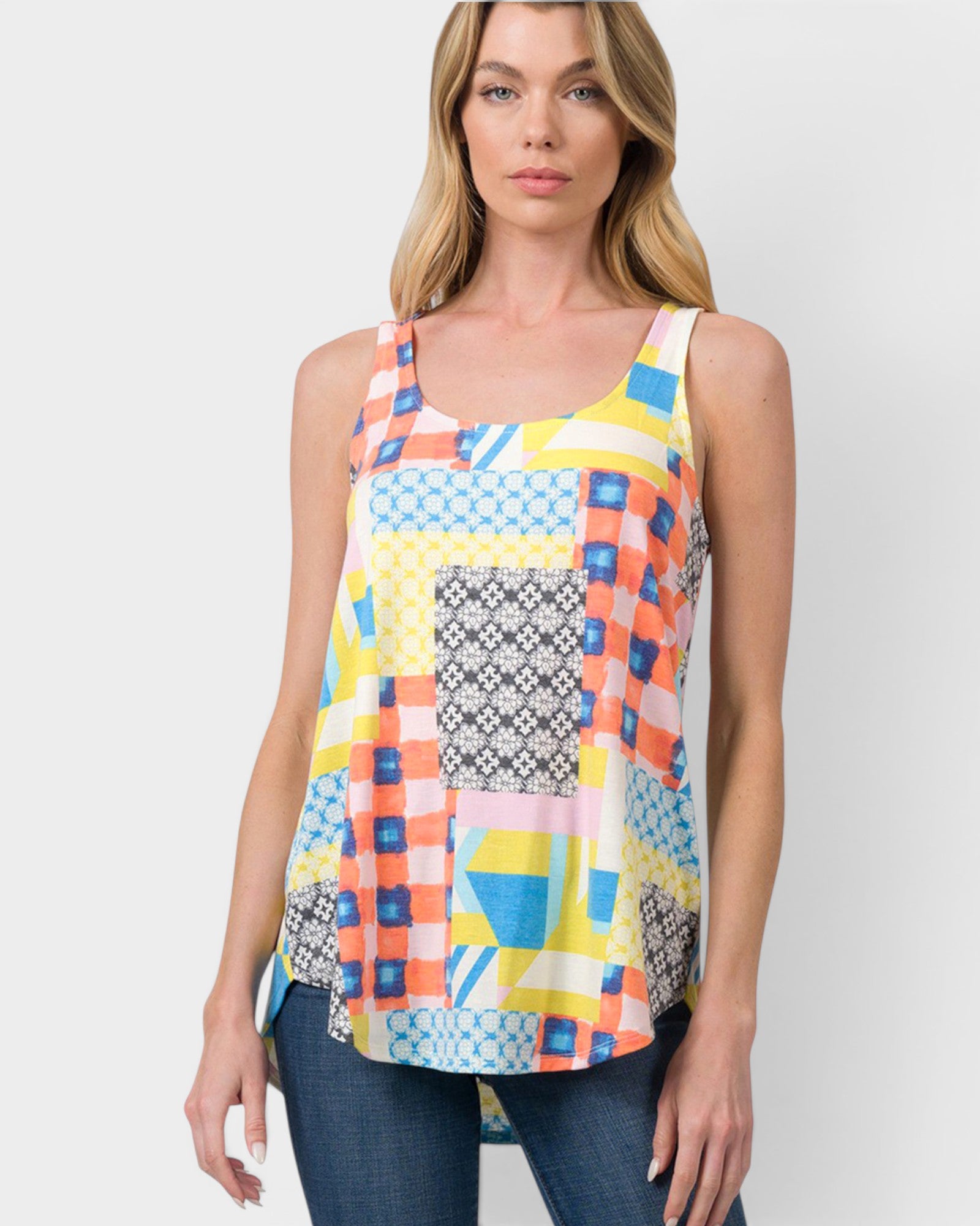 Woman wearing a colorful geometric patterned tank top against a white background
