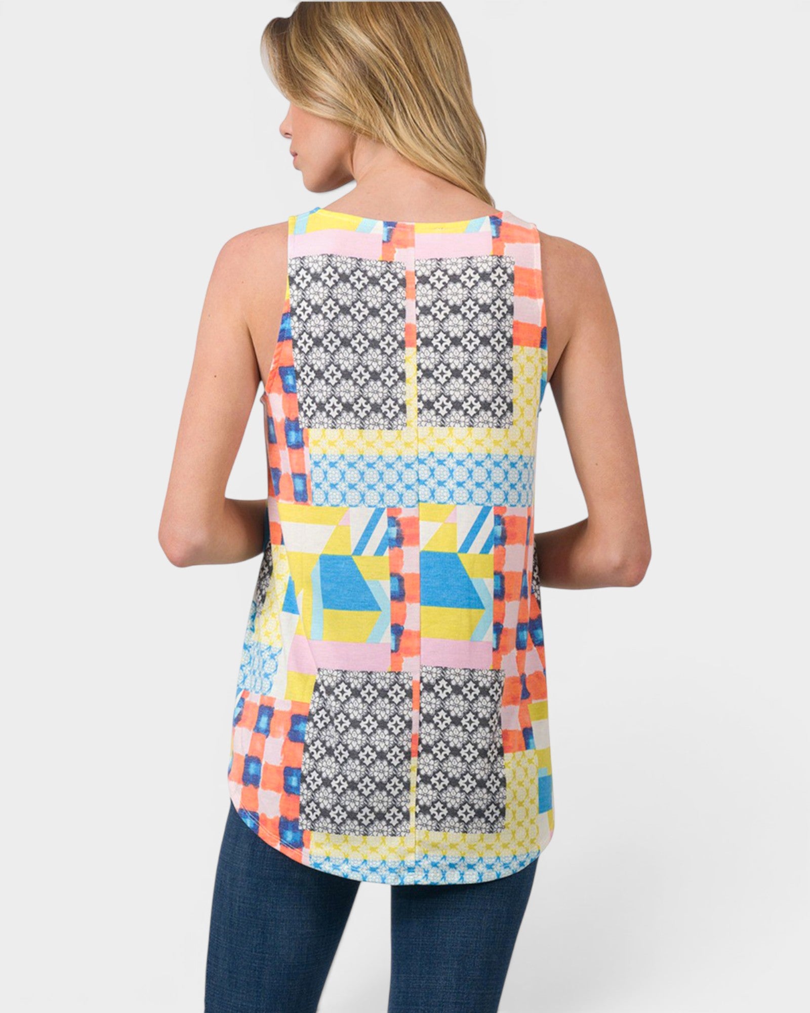 Woman wearing a colorful patchwork sleeveless top on a white background
