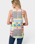 Woman wearing a colorful patchwork sleeveless top on a white background