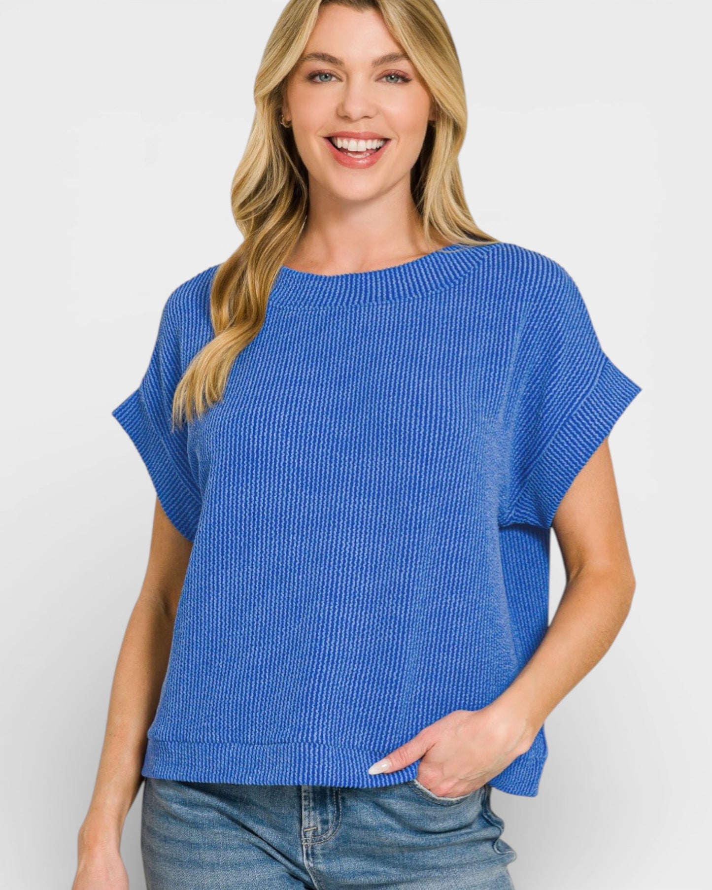 Woman wearing a blue sweater against a white background
