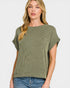 Woman wearing a green ribbed sweater and blue jeans on a white background