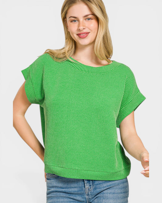Woman wearing a green sweater against a white background