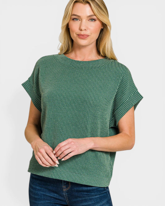 Woman wearing a green textured top against a white background