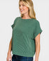 Woman wearing a green sweater against a white background