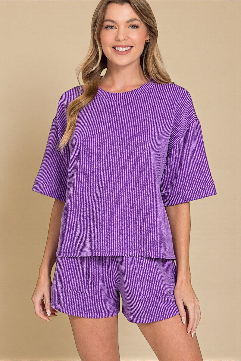 Woman wearing a purple checkered outfit on a beige background