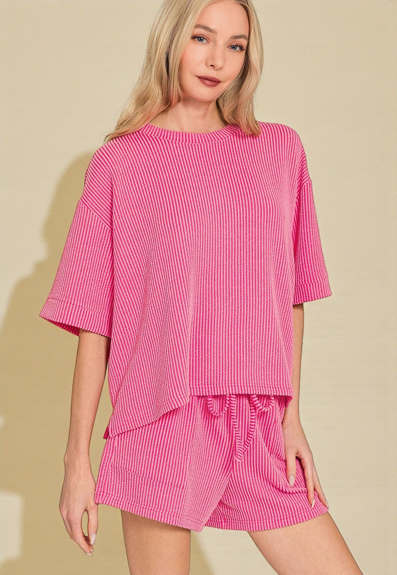 Woman wearing a pink dress with a plain background