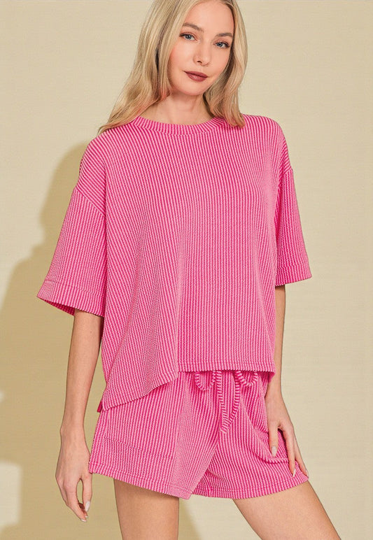 Woman wearing a pink dress with a plain background